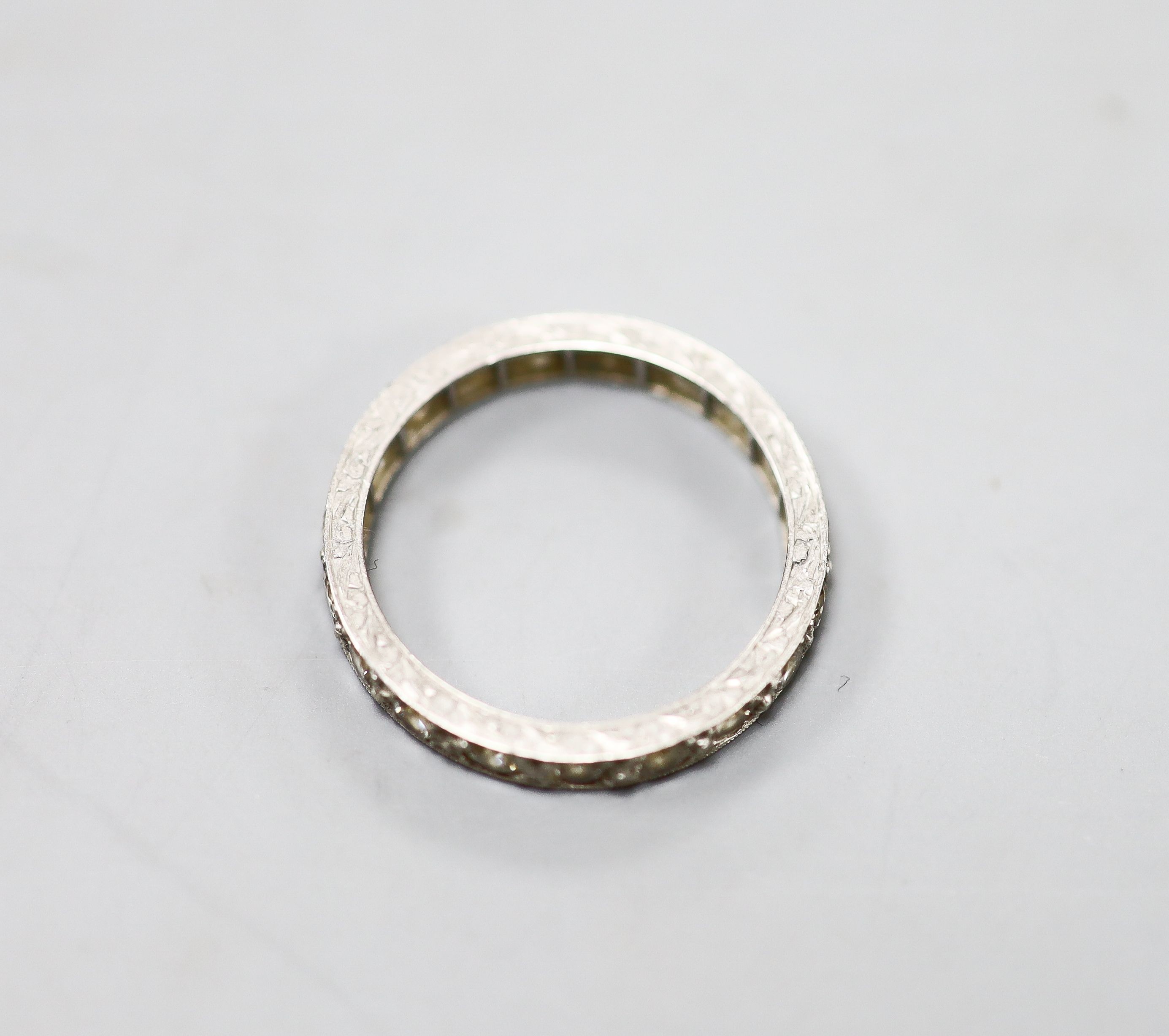 An engraved white metal and diamond set full eternity ring, size P, gross weight 4.1 grams.